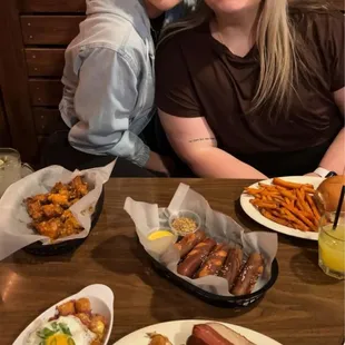 Hot dog with loaded breakfast tots, sweet potato fries, boneless wings, and pretzel sticks! Yum!