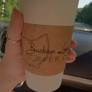 a hand holding a cup of coffee
