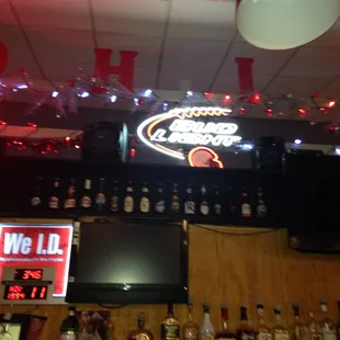 a bar with liquor bottles and a television