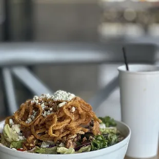 a bowl of salad and a cup of coffee