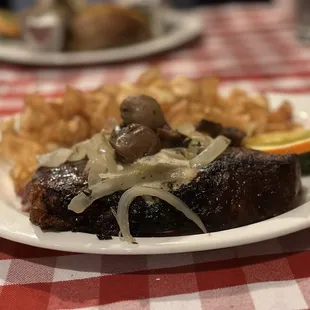 a plate of steak and potatoes