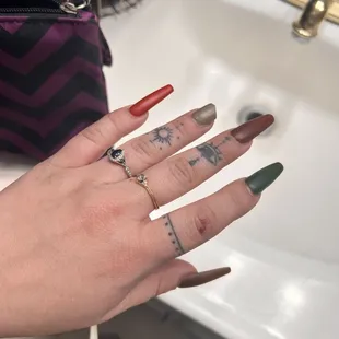 a woman's hand with red and green nails