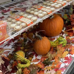 a display of pumpkins and cupcakes