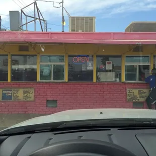 two men standing outside of a restaurant