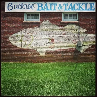 a fish painted on a brick wall