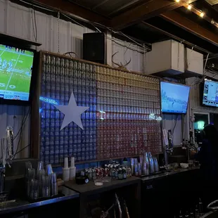 a bar with several televisions