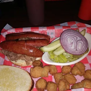 Chopped beef sandwich topped with hot link sausage, okra and all the fixins