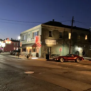 a red car parked in front of a restaurant