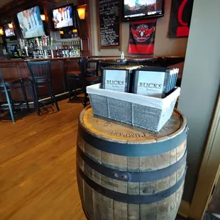 a wooden barrel with beer on top