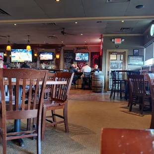 people sitting at tables and watching tvs