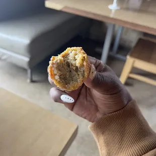 a hand holding a muffin
