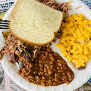 ows a pulled pork sandwich, baked beans, and macaroni and cheese