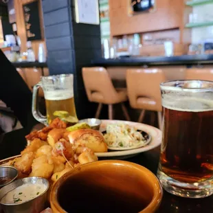 a plate of food and a mug of beer