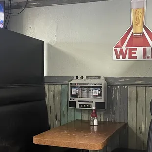 Old fashion jukebox in the middle of the table. High extended walls just in case of a food fight?