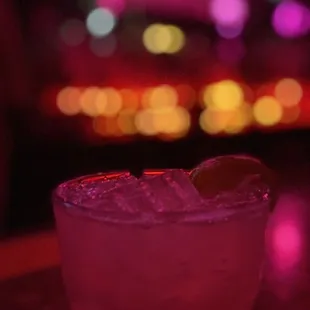 My cocktail backlit by the ambience of the bar.