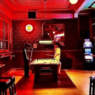 a pool table and arcade machines