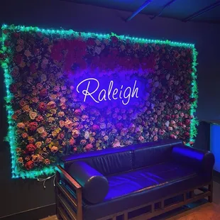 Couch upstairs with pretty Raleigh neon sign!