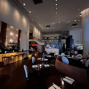 a view of a restaurant with a bar in the background