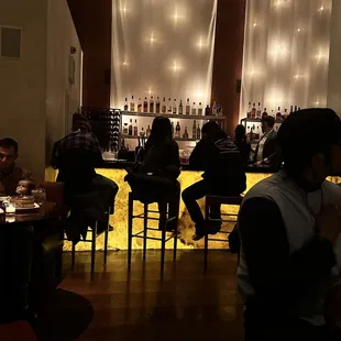 a group of people sitting at a bar