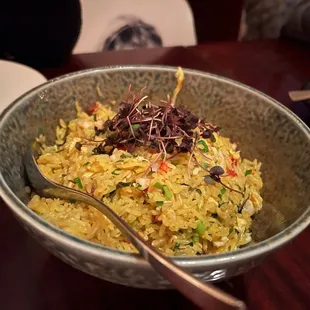 a bowl of rice with a spoon in it