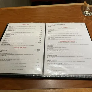 a menu and a glass of water