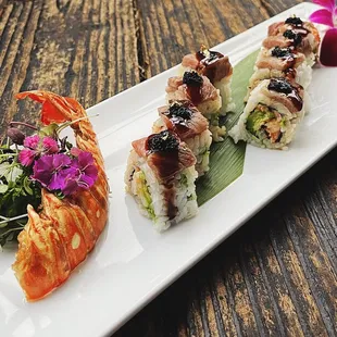 Surf &amp; Turf Lobster &amp; mayo baked, shiso leaf, garlic butter, masago, avocado in soy paper topped with seared wagyu, eel sauce, black tobiko