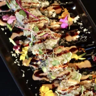 OMF (Oh My Fish) Roll Tuna, yellowtail, shrimp, kani kama, masago topped with avocado, spicy mayo, eel sauce and tempura flakes