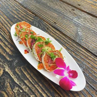 I Like It Raw Tuna, Salmon, yellowtail, spicy tuna, masago, cucumber and avocado topped with garlic ponzu wrapped in soy paper