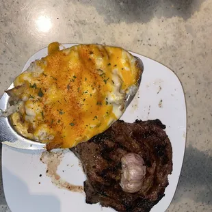 Medium Ribeye topped with a half garlic clove, side of Bayou Potato