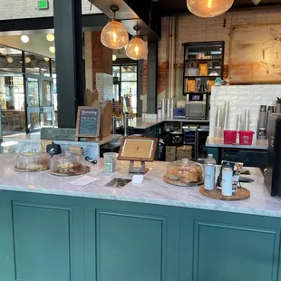 a counter with coffee and pastries on it