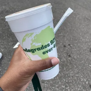 a hand holding a cup of coffee