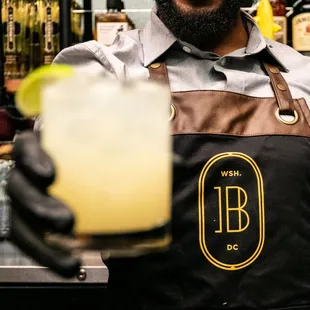 a bartender holding a drink