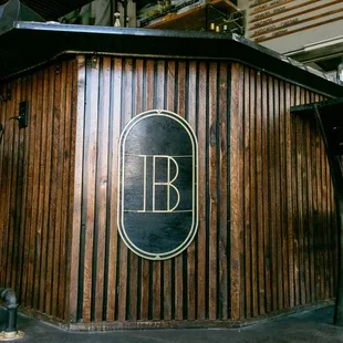 a wooden bar with a sign on it