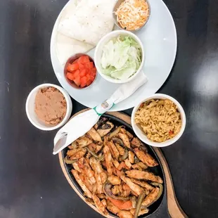 a plate of chicken, rice, and vegetables