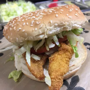 Fried catfish on a toasted sesame seed bun, dressed.