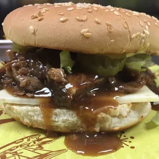 Roast beef on a toasted bun with pepper jack cheese, dressed.