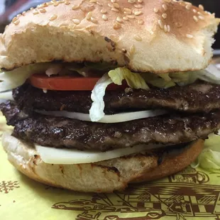 A double Lot-O-Burger with Swiss cheese dressed in a toasted bun.