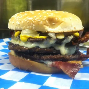 A double Lot-O-Burger with 1 patty of hot sausage, Pepperjack, 4 pieces of bacon mayo, x mustard, x onions.