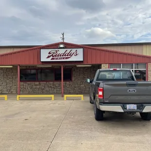 two trucks parked in front of a restaurant