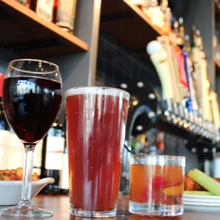 two glasses of beer and a plate of food