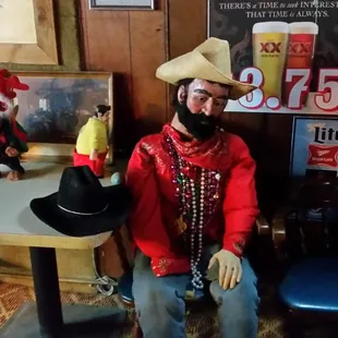 a man wearing a cowboy hat and a red jacket