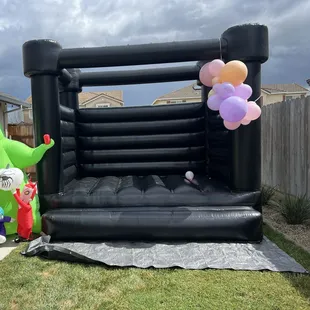 Black bounce house with the little amount of balloons we had left from the arch I made