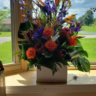 Requested tropical arrangement and they captured the vision beautifully. Birds of paradise, ferns all picking up the warm Aloha feeling.