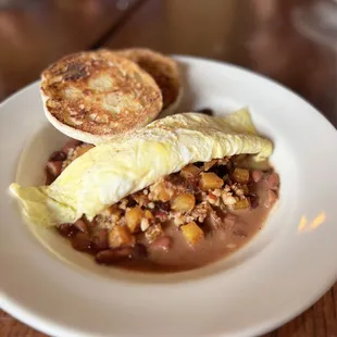 Cajun Pork Boudin Hash Pork Boudin (Cajun rice and pork &quot;sausage&quot;) sautéed with diced potatoes, topped with 2 eggs.