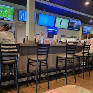 Inside bar with booths across, lots of TV&apos;s