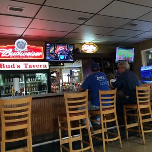 a bar with people sitting at the bar