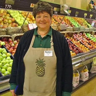 a woman standing in front of a produce section