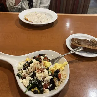 a bowl of scrambled eggs and bread