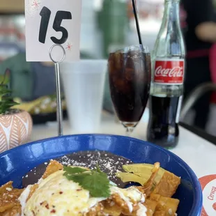 a plate of nachos and a coke