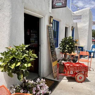 a restaurant with a red wagon outside